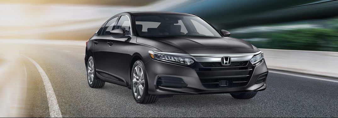 Metallic 2019 Honda Accord cruises around a corner on a track. Is a CD player inside?