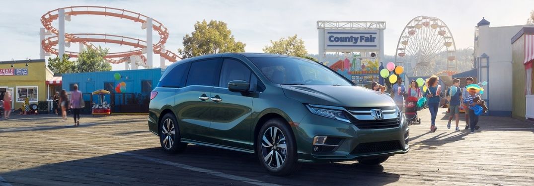 Green 2020 Honda Odyssey with a County Fair in the Background
