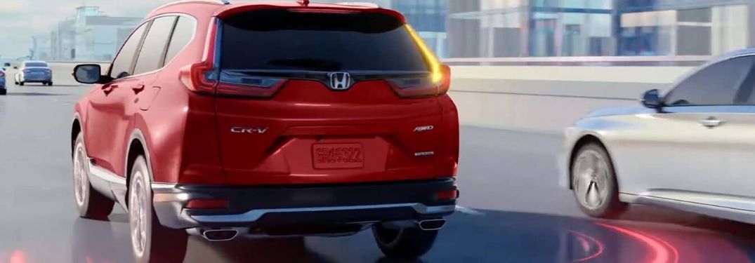 Red 2020 Honda CR-V on Freeway with Illustration of Rear Blind Spot Monitor