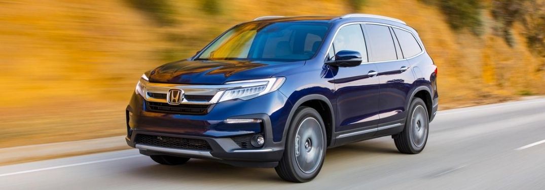 Blue 2021 Honda Pilot Driving on a Country Road