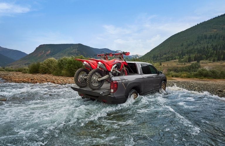 2021 Honda Ridgeline with Dirt Bikes in the Bed Fording River