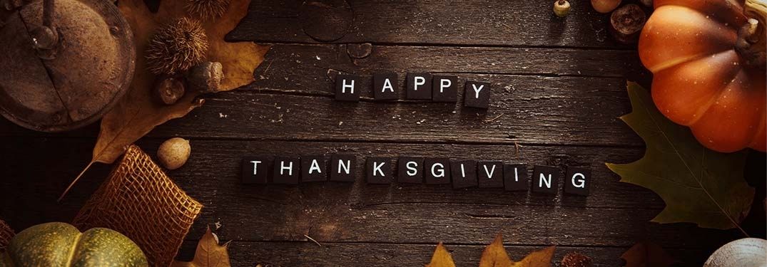 Fall Background with Scrabble Tiles Spelling Happy Thanksgiving