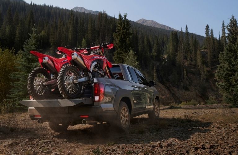 Gray 2021 Honda Ridgeline Rear Exterior with Dirt Bikes in the Bed