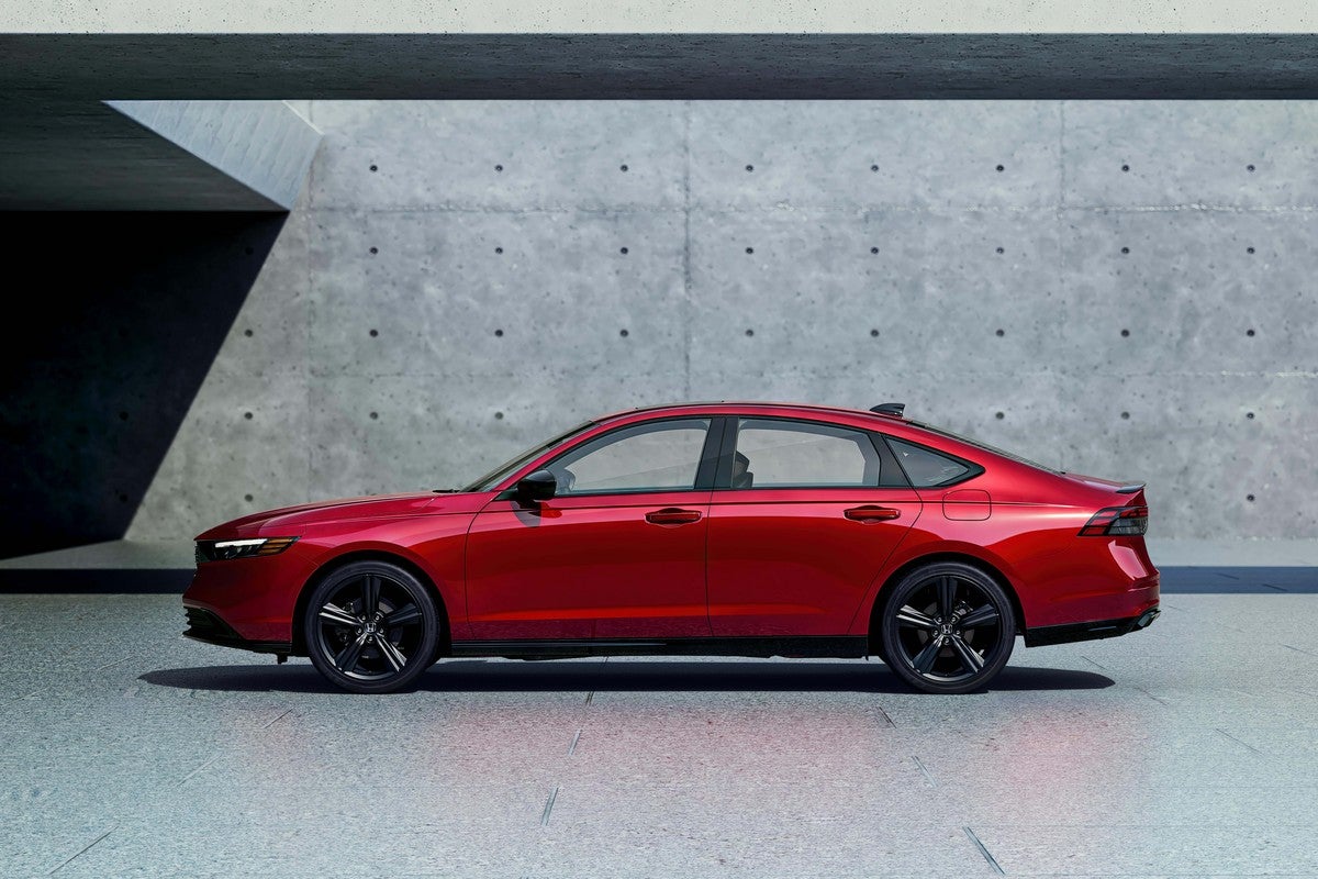 A red 2026 Honda Accord in Phoenix is parked facing left in front of a grey concrete wall.