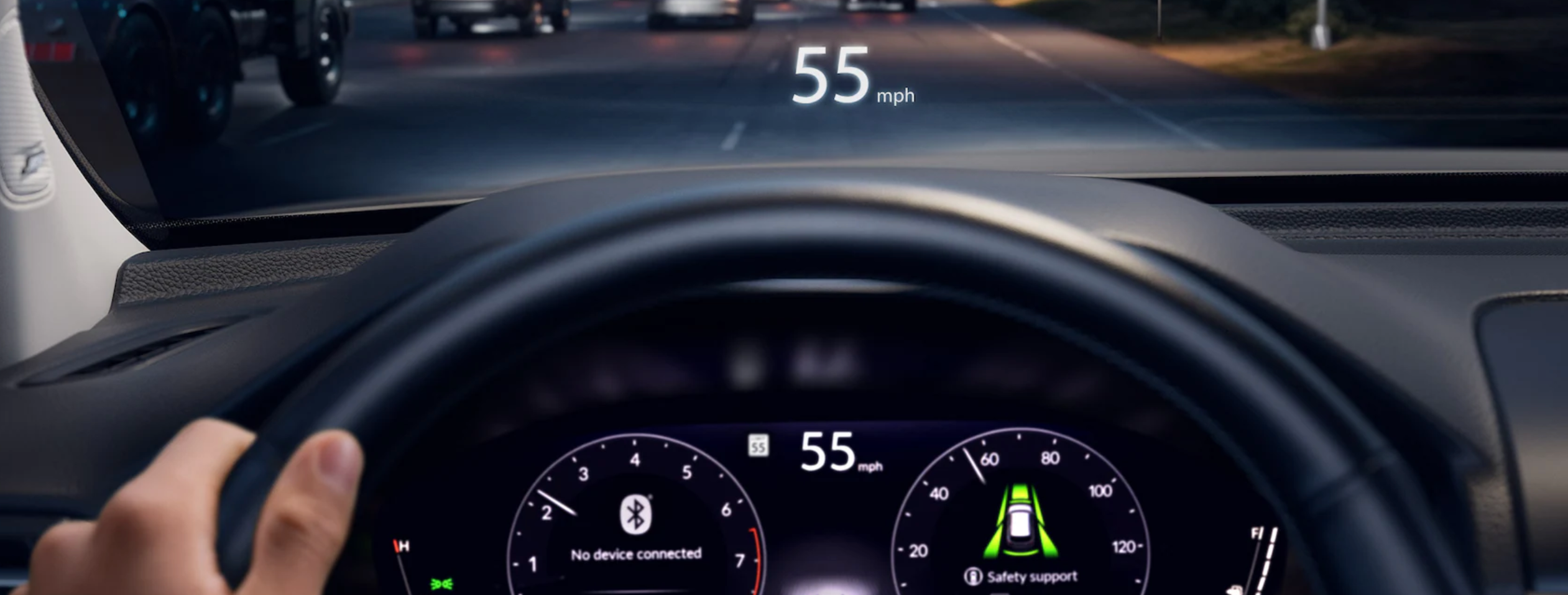 A low-angle interior shot from the driver's perspective of a Honda Passport TrailSport SUV at night. The driver's hands are on the steering wheel, and the digital instrument cluster and a heads-up display on the windshield both show the vehicle's speed at 55 mph. The car is on a highway, with the taillights of other vehicles visible ahead.