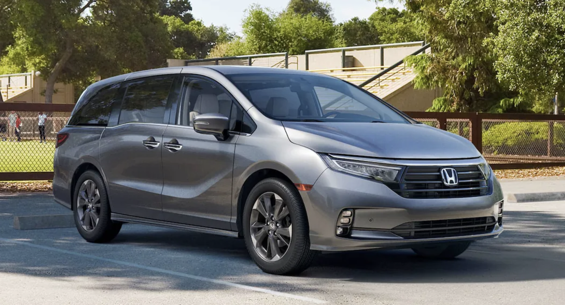 Silver 2020 Honda Odyssey LX Side Exterior with a Baseball Team and Black 2020 Honda Odyssey LX Shown Text in Lower Right
