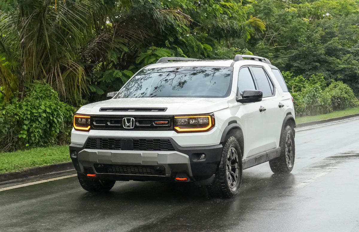 Silver 2019 Honda Passport Next to a River with a Kayak on the Roof and White *2019 Honda Passport Elite Shown Text