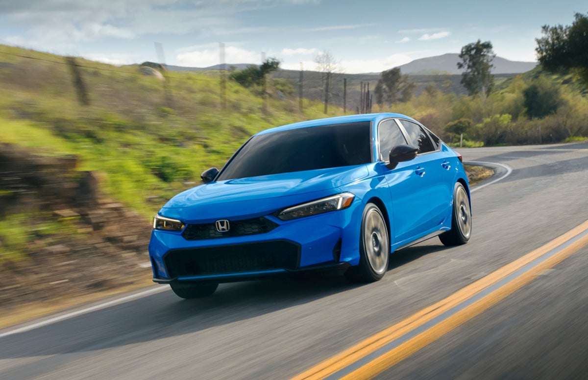 Silver 2020 Honda Civic Hatchback Front Exterior in Desert with Black Prototype Vehicle Shown Text in Lower Right Corner